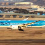 A Korean Air Boeing 787-9 Dreamliner aircraft captured during landing at Taipei International Airport with an American Airlines aircraft in the apron area
