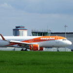 EasyJet aircraft after landing at Glasgow Airport behind grass and under a grey sky