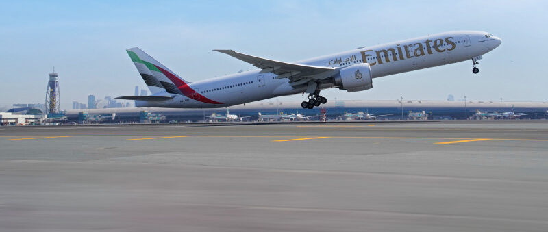 Right-side view of an Emirates Boeing 777-300ER aircraft, taking off from Dubai International Airport