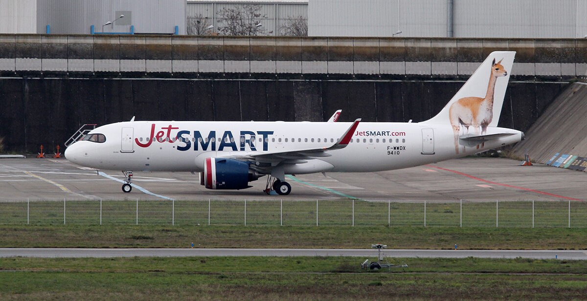 JetSMART Airbus aircraft on the tarmac, grass in foreground.