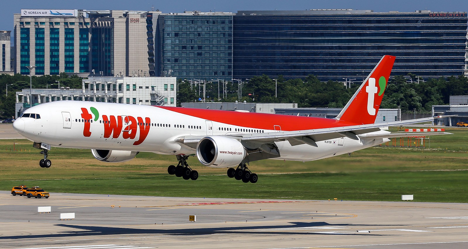 A Boeing 777-300ER aircraft captured at Seoul Incheon Airport during Landing with Grand Hyatt Hotel as the backdrop