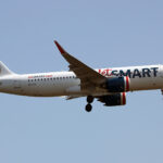 JetSmart Airbus A320 flying through the blue sky.
