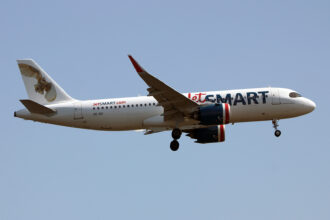 JetSmart Airbus A320 flying through the blue sky.