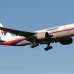 Malaysia Airlines Boeing 777 flying through the blue sky