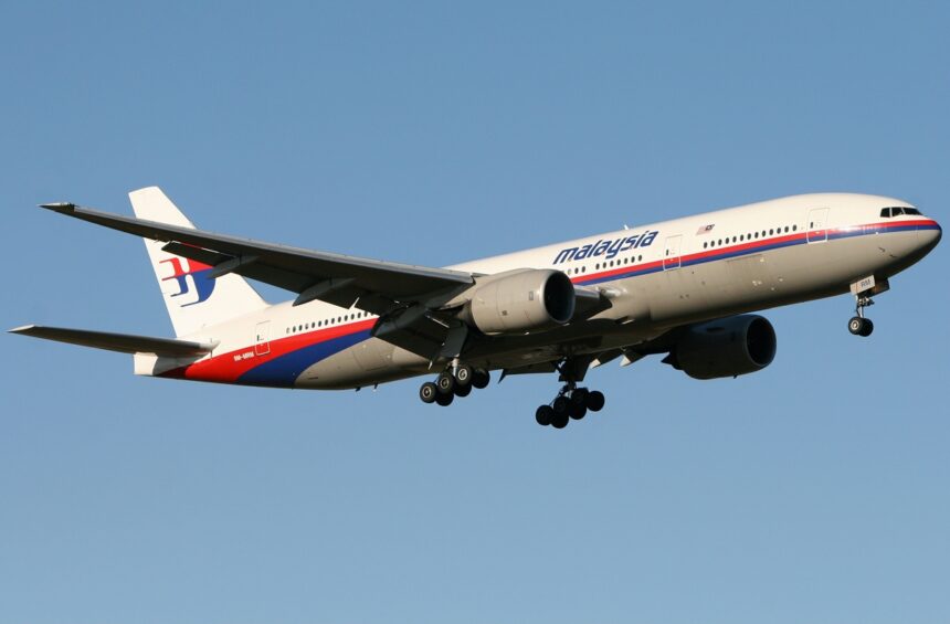 Malaysia Airlines Boeing 777 flying through the blue sky