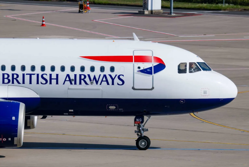 A large white British Airways jetliner waiting on the tarmac at an airport