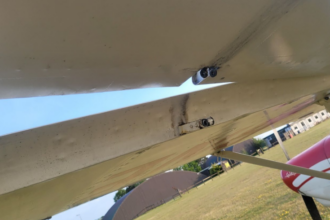 Left aileron outboard hinge with missing clevis pin. Photo taken from underneath.
