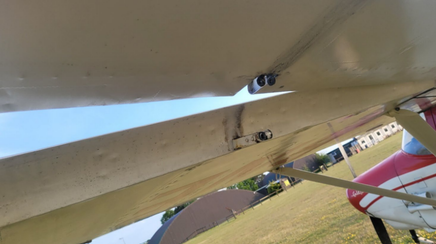 Left aileron outboard hinge with missing clevis pin. Photo taken from underneath.