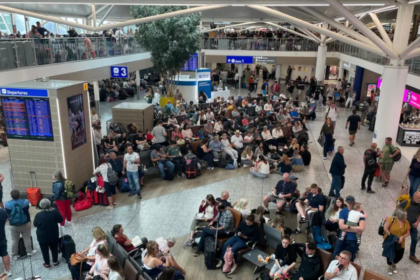 A busy airport waiting area filled with people sitting down