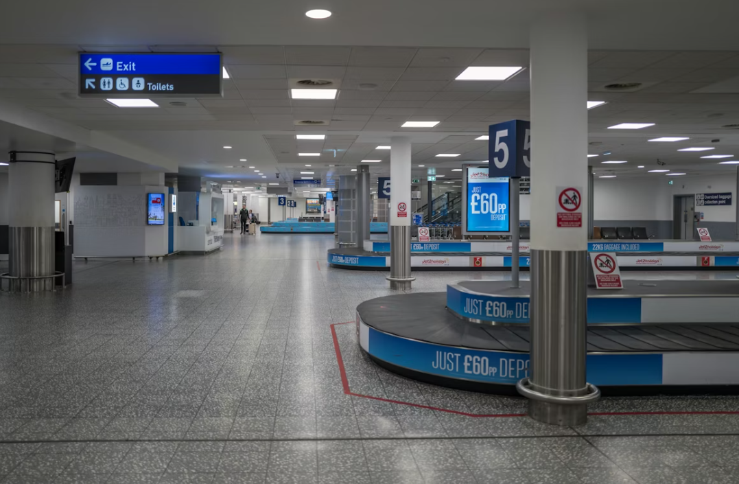 Empty airport baggage claim area with conveyor belts