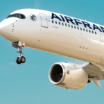 A large Air France jet flying through a blue sky