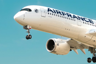 A large Air France jet flying through a blue sky