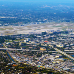 An aerial view of an airport under a blue sky