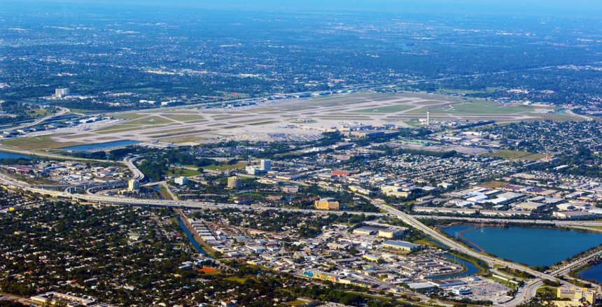 An aerial view of an airport under a blue sky