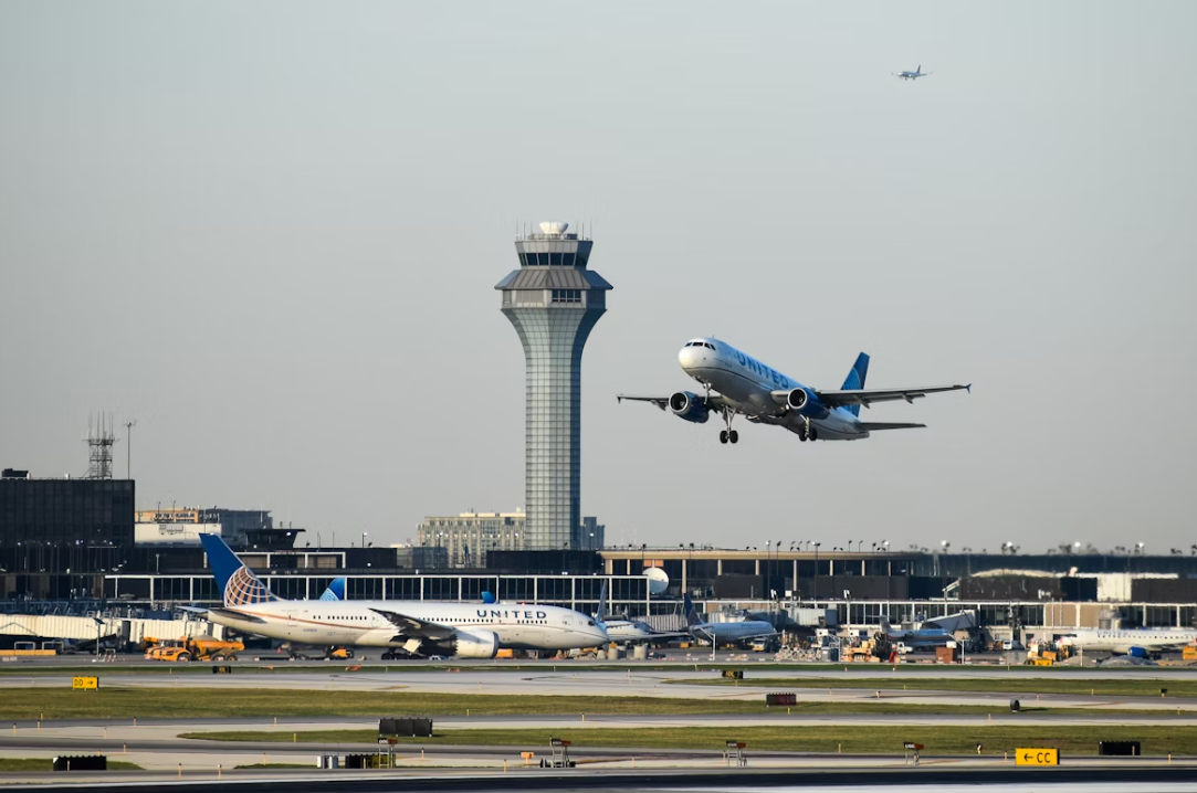A white United jetliner taking off from an airport