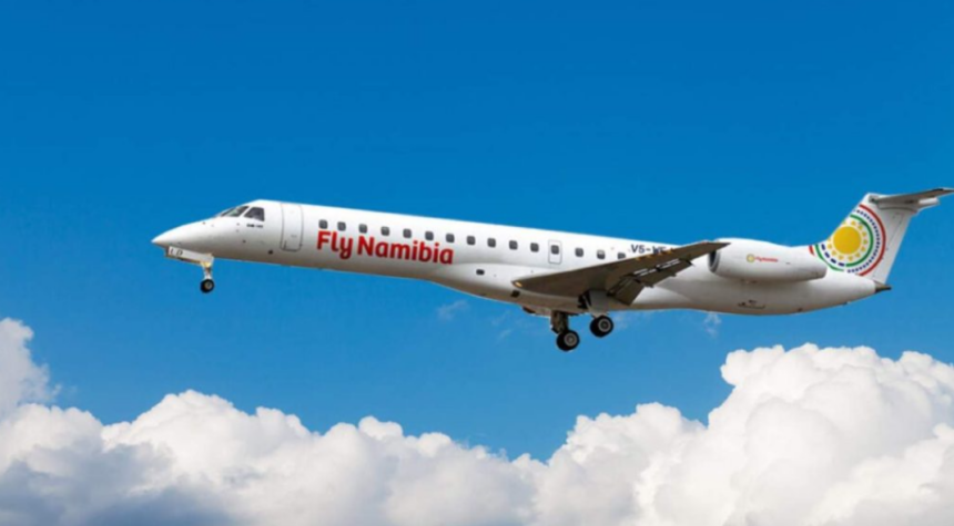 A large white jetliner flying in a blue sky with clouds