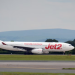 A large white jetliner sitting on an airport runway
