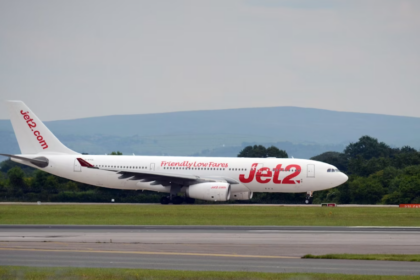 A large white jetliner sitting on an airport runway