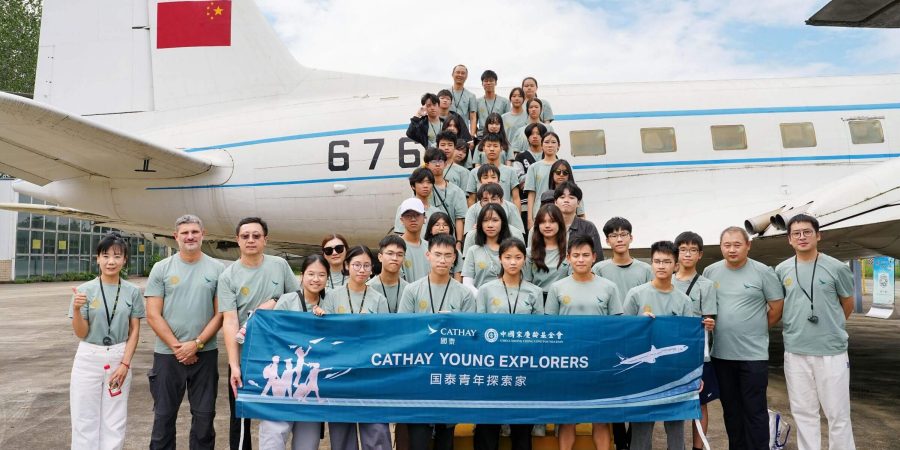 Cohort of students in front of an aircraft on Cathay Young Explorers Programme.