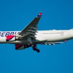 Air Serbia Airbus A330-200 flying on blue sky near JFK