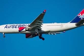 Air Serbia Airbus A330-200 flying on blue sky near JFK