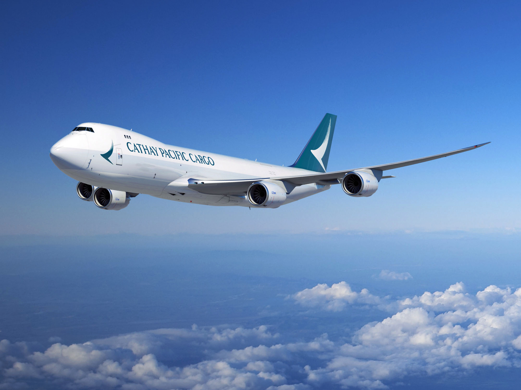 Cathay Pacific Cargo aircraft amid blue skies and clouds below it, flying through the air.