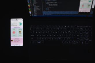 A smartphone laying next to a laptop