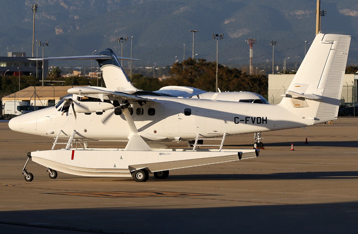 A DHC-6-400 aircraft in its all-white livery taxiing at Palma Mallorca Airport in Spain