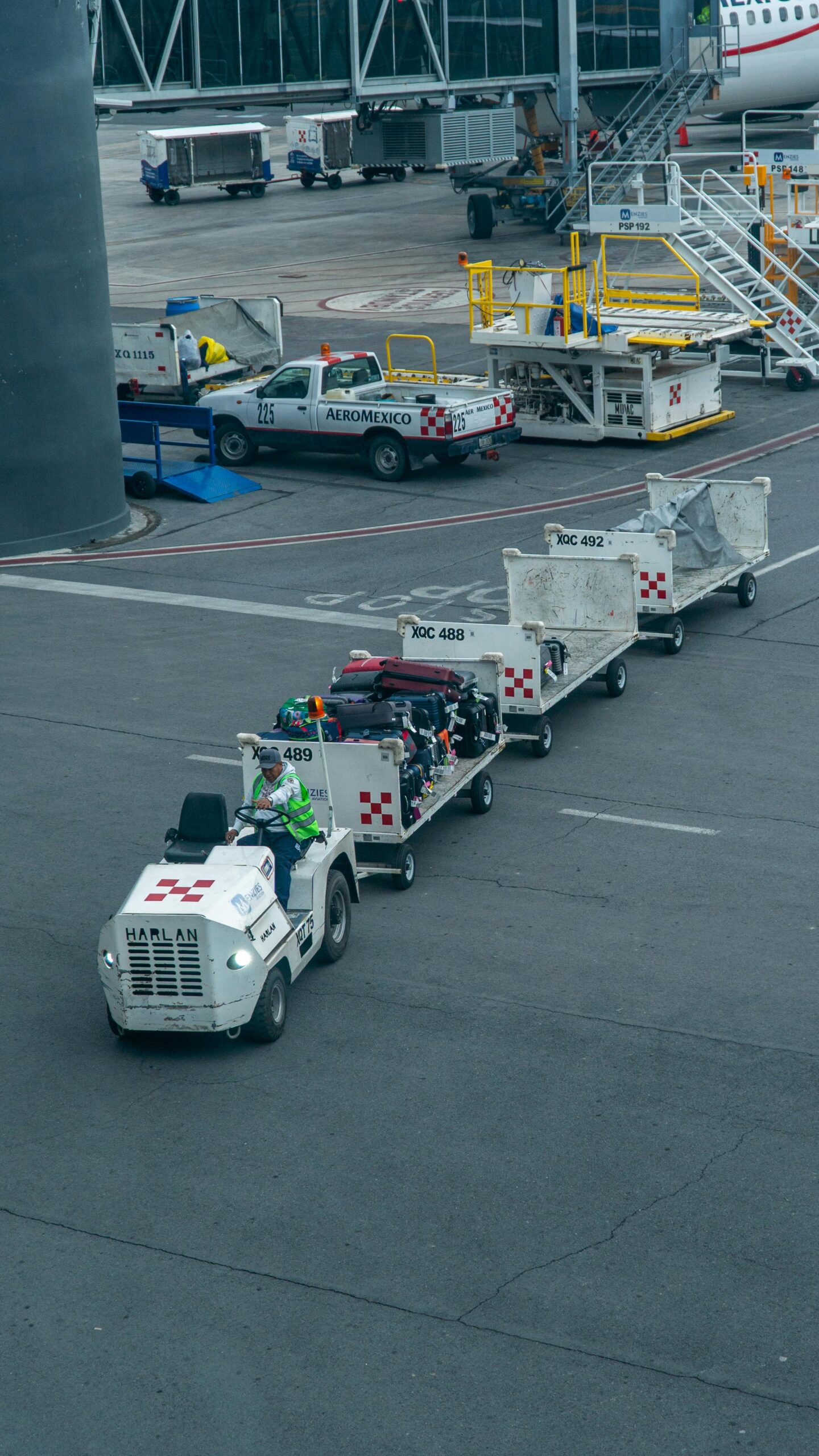 Ground Crew Member Driving Vehicle with Baggage