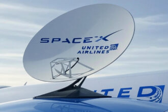 United Airlines aircraft, with a satellite on the side which says "SpaceX United Airlines", blue sky in the background.