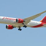 A white and red avianca plane.