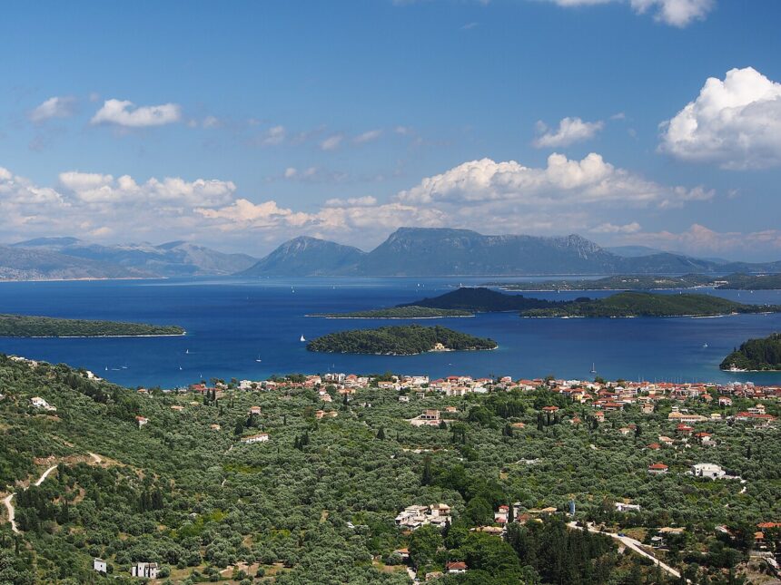 View of small green islands in the Ionian Sea near Lefkada, Greece, with calm blue water, rocky shoreline.