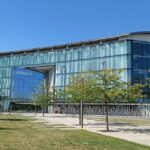 Airbus Headquarters in Toulouse. It is a sunny day and the building's facade is full of glass.