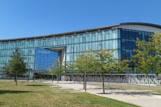 Airbus Headquarters in Toulouse. It is a sunny day and the building's facade is full of glass.