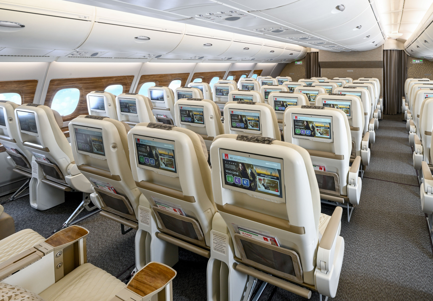Premium Economy onboard the A380. Rows of seats are shown featuring screens