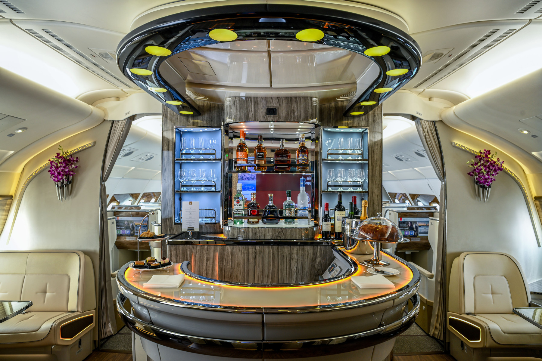 An onboard lounge featuring glasses and bottles.