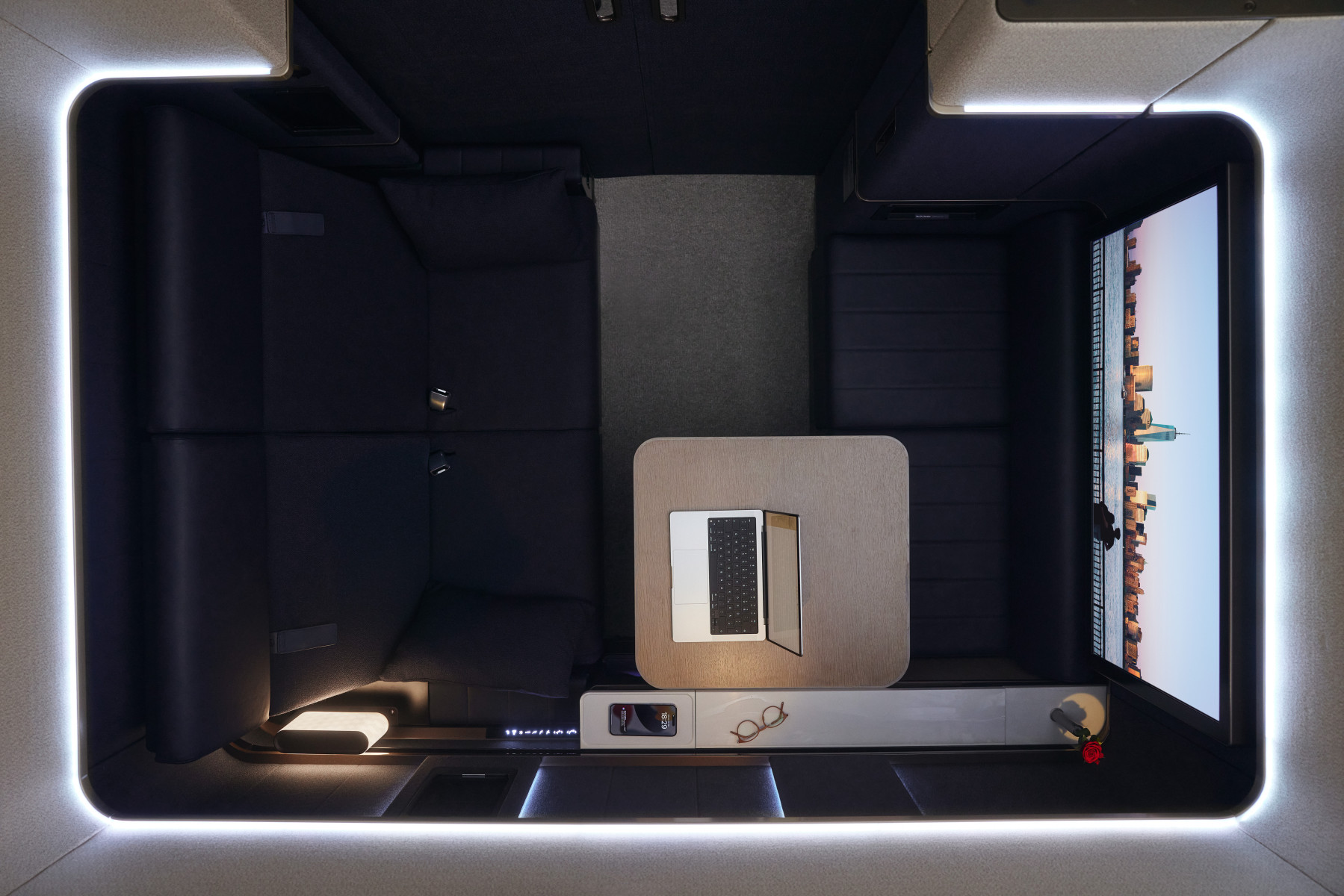 The double suite in a navy colour from Birds Eye view. features two convertible seats, a small desk with laptop and wide screen television