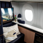 Lufthansa Allegris First Class single suite, in a navy blue colour with furnishings and a convertible seat