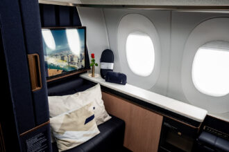 Lufthansa Allegris First Class single suite, in a navy blue colour with furnishings and a convertible seat