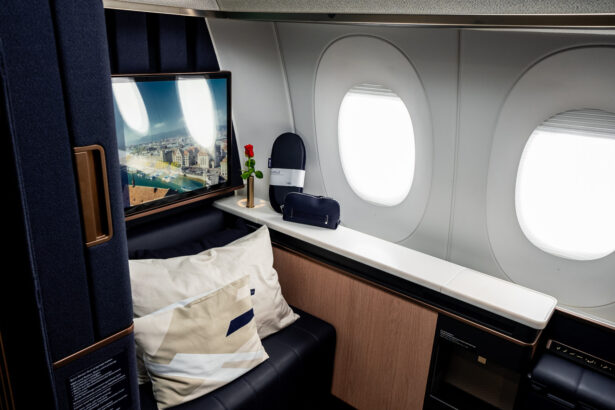 Lufthansa Allegris First Class single suite, in a navy blue colour with furnishings and a convertible seat