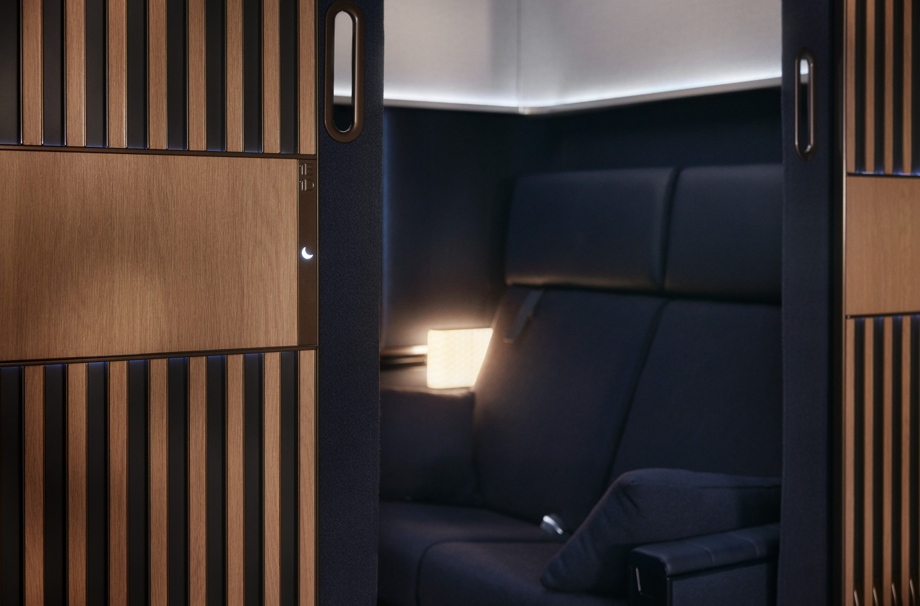 the double suite from the outside with sliding wooden doors and the double seats converting into a bed