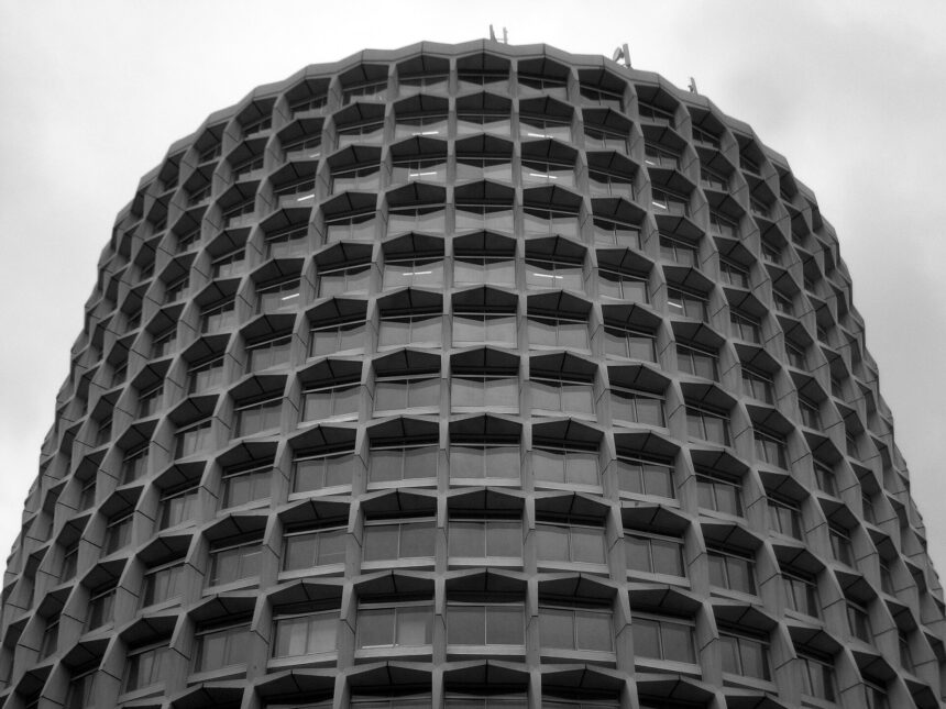 The Civil Aviation Authority UK's Head Office in London, taken from below looking up. The building occupies the whole photo, except for a strip of cloudy sky across the top and in the top corners.