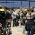 Image shows a queue of passengers at Lyon Airport Saint-Exupéry (LYS)