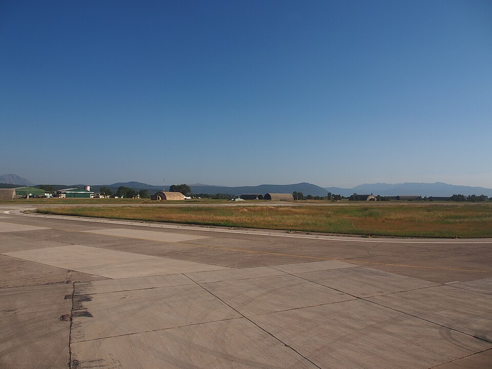 Aktion National Airport terminal area with small aircraft shelters and parked planes on the apron.