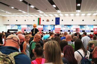 Passengers wait in a long queue at passport control inside Burgas Airport, Bulgaria, as travellers line up for border checks.