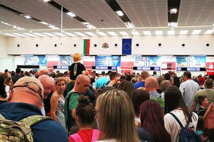 Passengers wait in a long queue at passport control inside Burgas Airport, Bulgaria, as travellers line up for border checks.