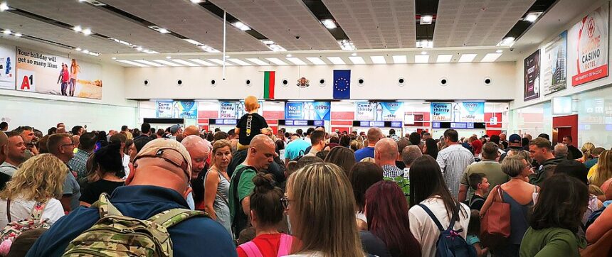Passengers wait in a long queue at passport control inside Burgas Airport, Bulgaria, as travellers line up for border checks.
