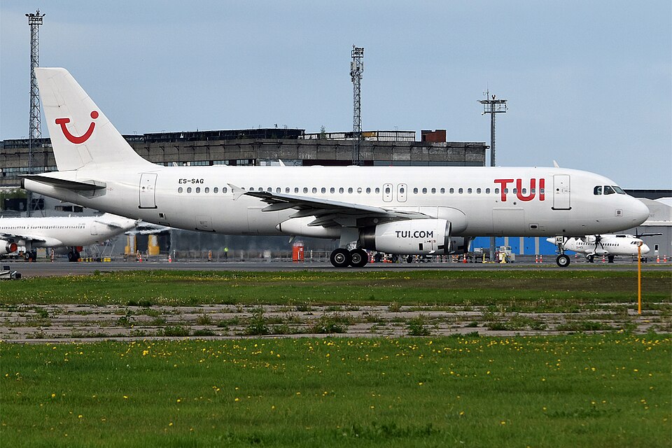 Tui Airbus A320-232 on runway at international airport.