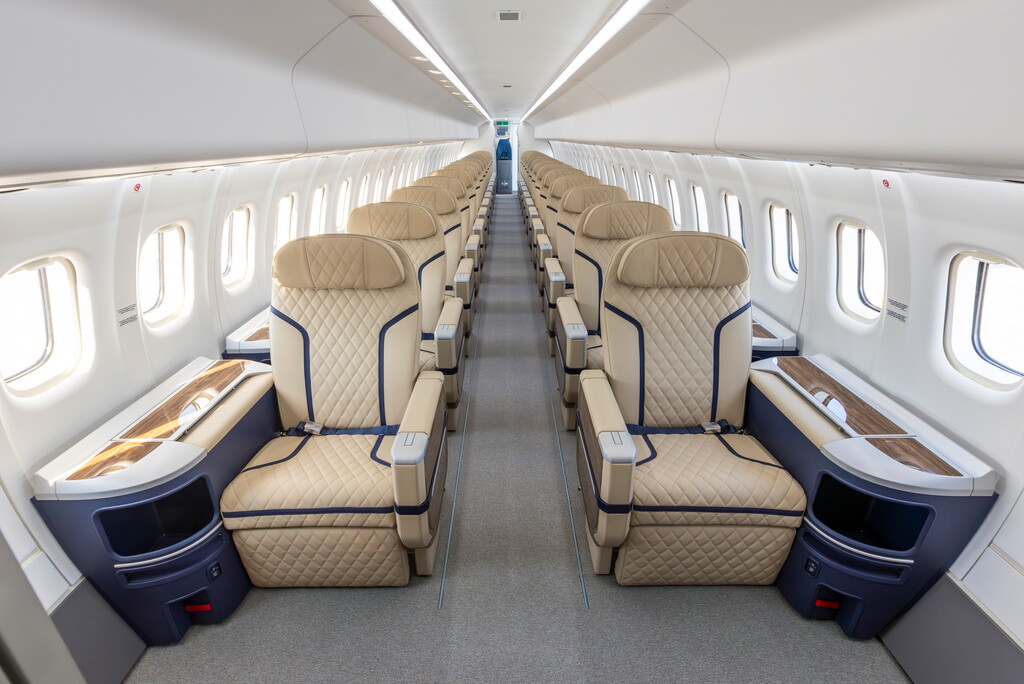 Interior view of the new ATR HighLine all-business cabin aboard Berjaya Air's ATR72-600, featuring a 1-1 seat configuration with beige leather seats and overhead mood lighting