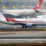 Air Algerie Boeing aircraft in the apron, white and red livery. A Turkish Airlines aircraft behind it.